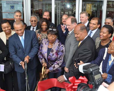 Mattapan Community Health Center ribbon cutting ceremony: Governor Deval Patrick, left, and Dr. Azzie Young, the president and CEO of the health center cut the ribbon this afternoon outside the new MCHC building at 1575 Blue Hill Ave. Photo by Bill Forry